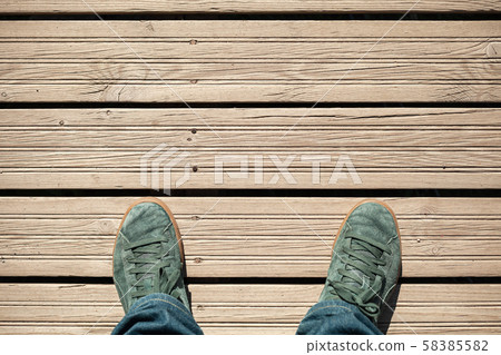 Green suede shoes on wooden floor 58385582