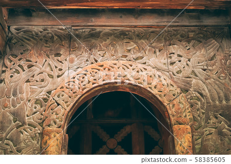 Borgund, Norway. Carved Details Of Famous Wooden Norwegian Landmark Stavkirke. Ancient Old Wooden Borgund, Norway. Carved Details Of Famous Wooden Norwegian Landmark Stavkirke. Ancient Old Wooden 58385605