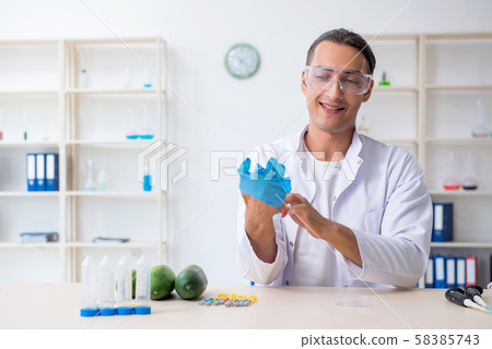 Male nutrition expert testing vegetables in lab Male nutrition expert testing vegetables in lab 58385743