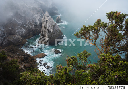 Lonely rock at rugged atlantic ocean coast in Sintra, Portugal 58385776