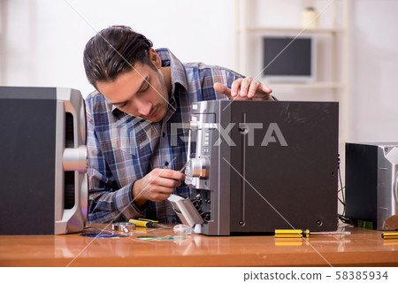 Young engineer repairing musical hi-fi system Young engineer repairing musical hi-fi system 58385934