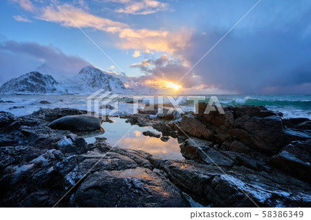 Coast of Norwegian sea on rocky coast in fjord on sunset 58386349