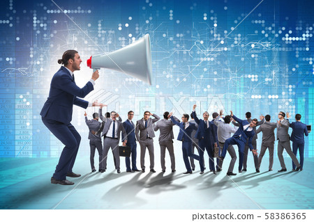 Businessman shouting through large loudspeaker Businessman shouting through large loudspeaker 58386365