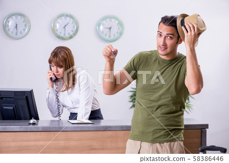 Young man at the hotel reception 58386446