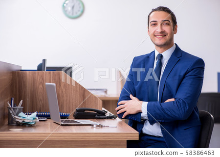 Young handsome businessman working in the office 58386463