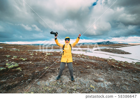 Aurlandsfjellet, Norway. Happy Young Woman Tourist Traveler Photographer With Camera Walking Near 58386647