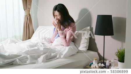 woman sick at home 58386899