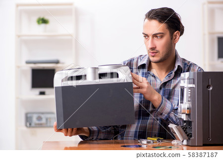 Young engineer repairing musical hi-fi system Young engineer repairing musical hi-fi system 58387187