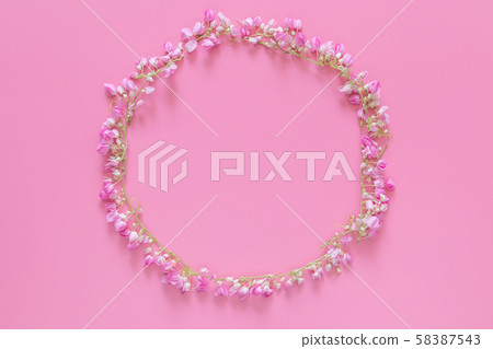 flat lay of Flower crown ,floral wreath circle made from pink flowers isolated on pink background, top view. flower creative composition with copy space 58387543