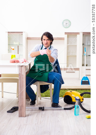 Young businessman cleaning the house Young businessman cleaning the house 58387788