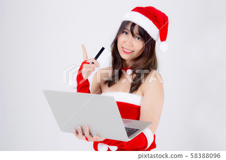 Beautiful portrait young asian woman in Santa holding credit card and laptop computer Beautiful portrait young asian woman in Santa holding credit card and laptop computer 58388096