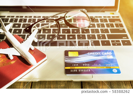 Passport and h credit card on laptop Passport and h credit card on laptop 58388262