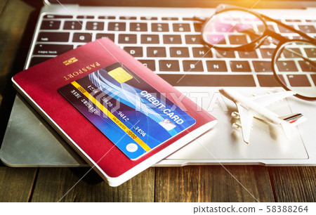 Passport and h credit card on laptop Passport and h credit card on laptop 58388264