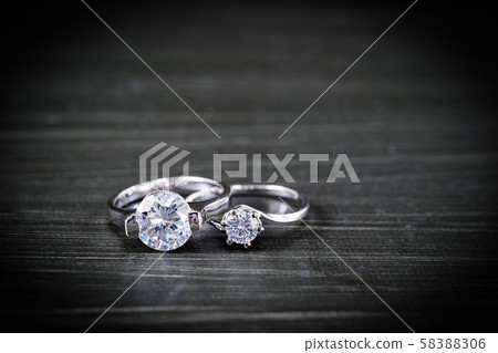 Diamond wedding rings on black background 58388306