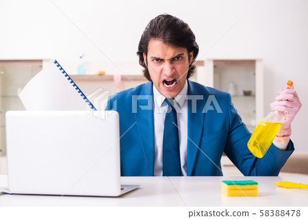 Young businessman cleaning the house 58388478