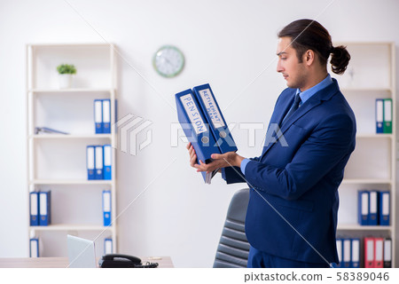 Young male accountant working in the office Young male accountant working in the office 58389046