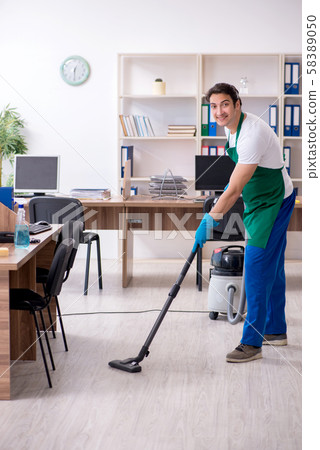 Young handsome contractor cleaning the office 58389050