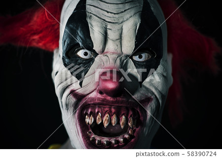 scary evil clown with a bloody mouth 58390724
