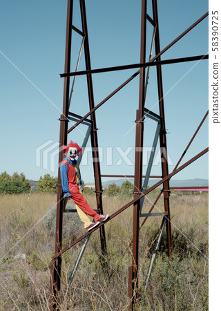 scary clown on an abandoned billboard. 58390725