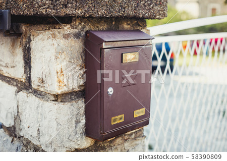 Old brown metallic retro post box on wall Old brown metallic retro post box on wall 58390809