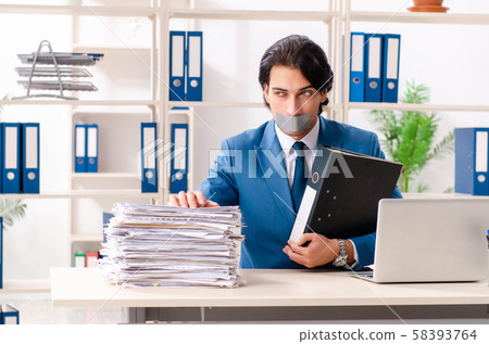 Young male employee with tape on the mouth 58393764