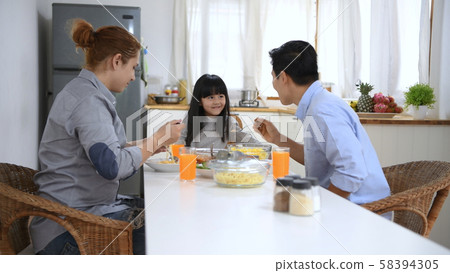 Family concept. Family eating together in the Family concept. Family eating together in the 58394305