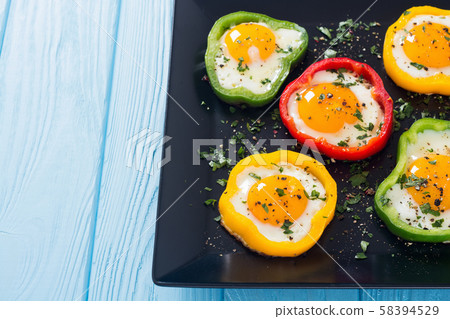 Yellow , red and green pepper with fried eggs 58394529