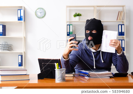 Male thief in balaclava in the office Male thief in balaclava in the office 58394680