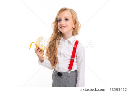 Little girl with long blonde hair in white shirt, red pull-ups, pants in cage, red socks and shoes Little girl with long blonde hair in white shirt, red pull-ups, pants in cage, red socks and shoes 58395412