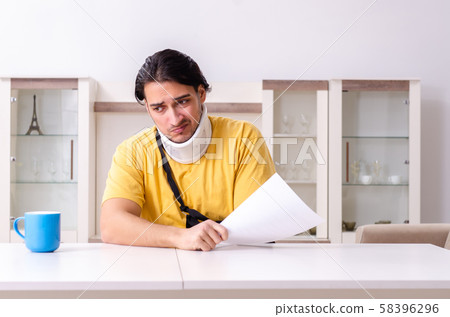 Young man after car accident suffering at home 58396296