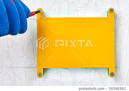 Installing of a plastic junction box in drywall. 58398381