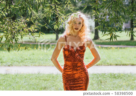 Portrait of beautiful girl in red short dress with 58398500