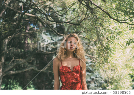 Portrait of beautiful girl in red short dress with 58398505