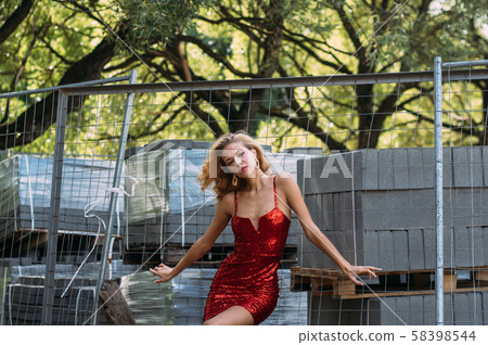Beautiful girl in red short dress with sequins Beautiful girl in red short dress with sequins 58398544