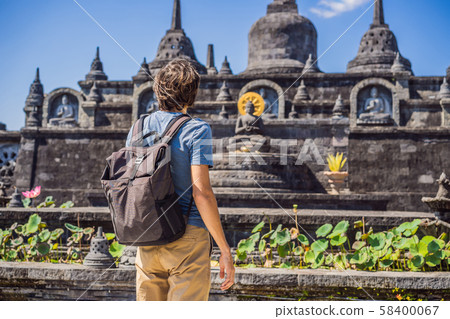 Young man tourist in budhist temple Brahma Vihara Arama Banjar Bali, Indonesia Young man tourist in budhist temple Brahma Vihara Arama Banjar Bali, Indonesia 58400067