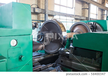 Rail wheelset in a lathe. Repair shop of railway Rail wheelset in a lathe. Repair shop of railway 58400347