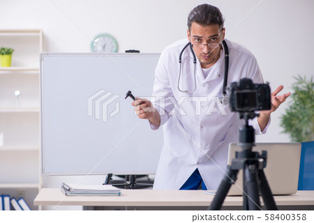 Young male doctor recording video for his blog 58400358