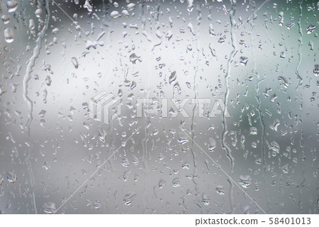 Rain drops on the window with green over background Rain drops on the window with green over background 58401013