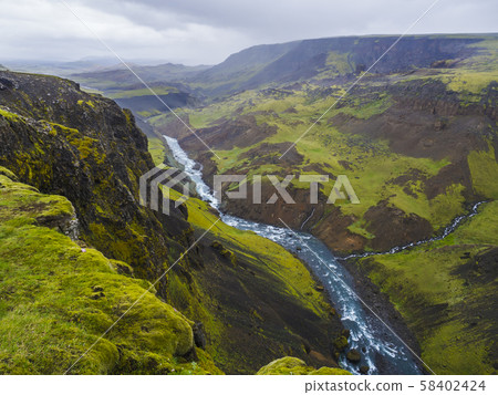 Landscape valley of river Fossa with blue water stream and green hills and moss covered cliffs, in Landscape valley of river Fossa with blue water stream and green hills and moss covered cliffs, in 58402424