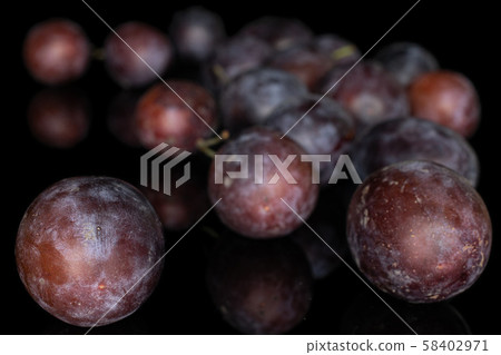 Sweet purple plum isolated on black glass Sweet purple plum isolated on black glass 58402971