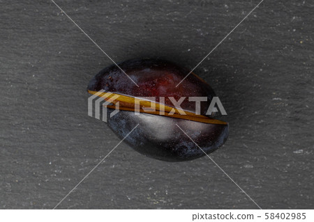 Fresh purple plum on grey stone 58402985