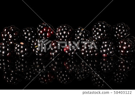 Fresh blackberry isolated on black glass Fresh blackberry isolated on black glass 58403122