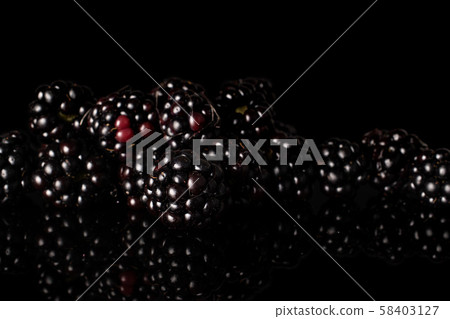 Fresh blackberry isolated on black glass 58403127