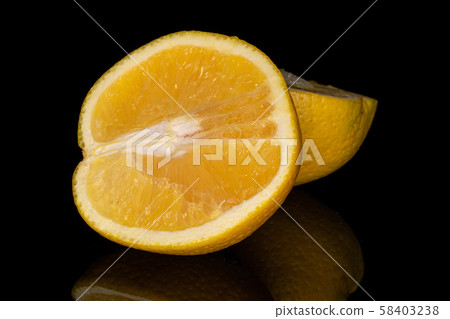 Fresh bright orange isolated on black glass Fresh bright orange isolated on black glass 58403238