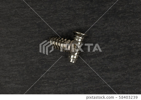 Glossy metallic bolt on grey stone 58403239