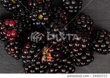 Fresh blackberry on grey stone Fresh blackberry on grey stone 58403315