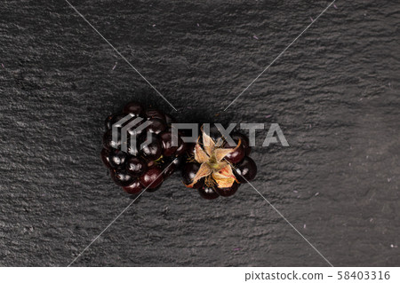 Fresh blackberry on grey stone Fresh blackberry on grey stone 58403316