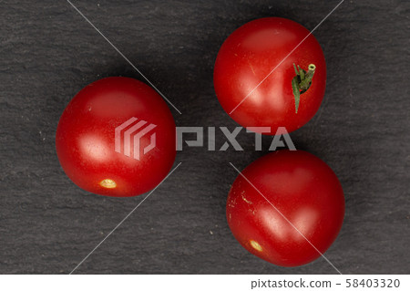 Fresh red tomato on grey stone 58403320