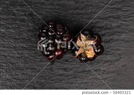 Fresh blackberry on grey stone Fresh blackberry on grey stone 58403321