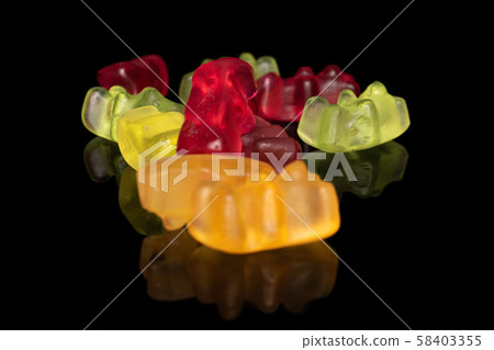 Colorful gummy bear isolated on black glass Colorful gummy bear isolated on black glass 58403355